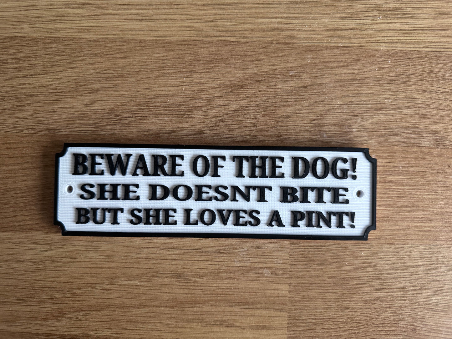 “Beware of the dog, she doesn’t bite but she loves a pint” funny plaque