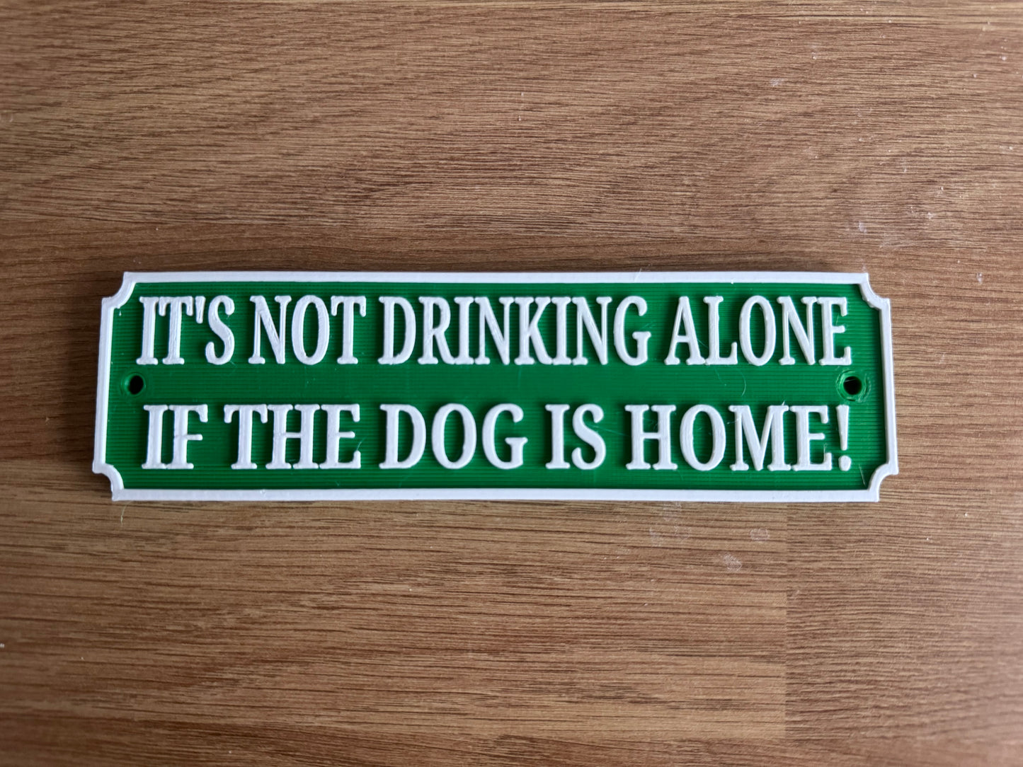 Funny bar plaque “it’s not drinking alone if the dog is home”