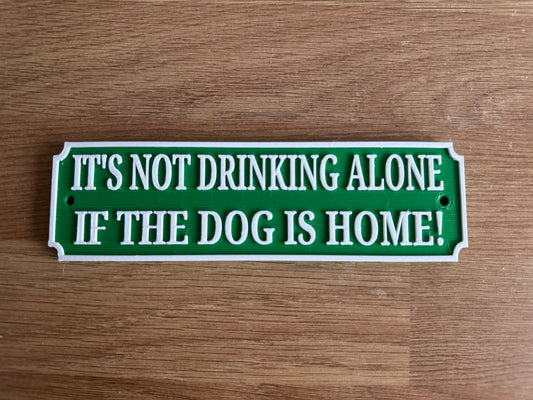 Funny bar plaque “it’s not drinking alone if the dog is home”