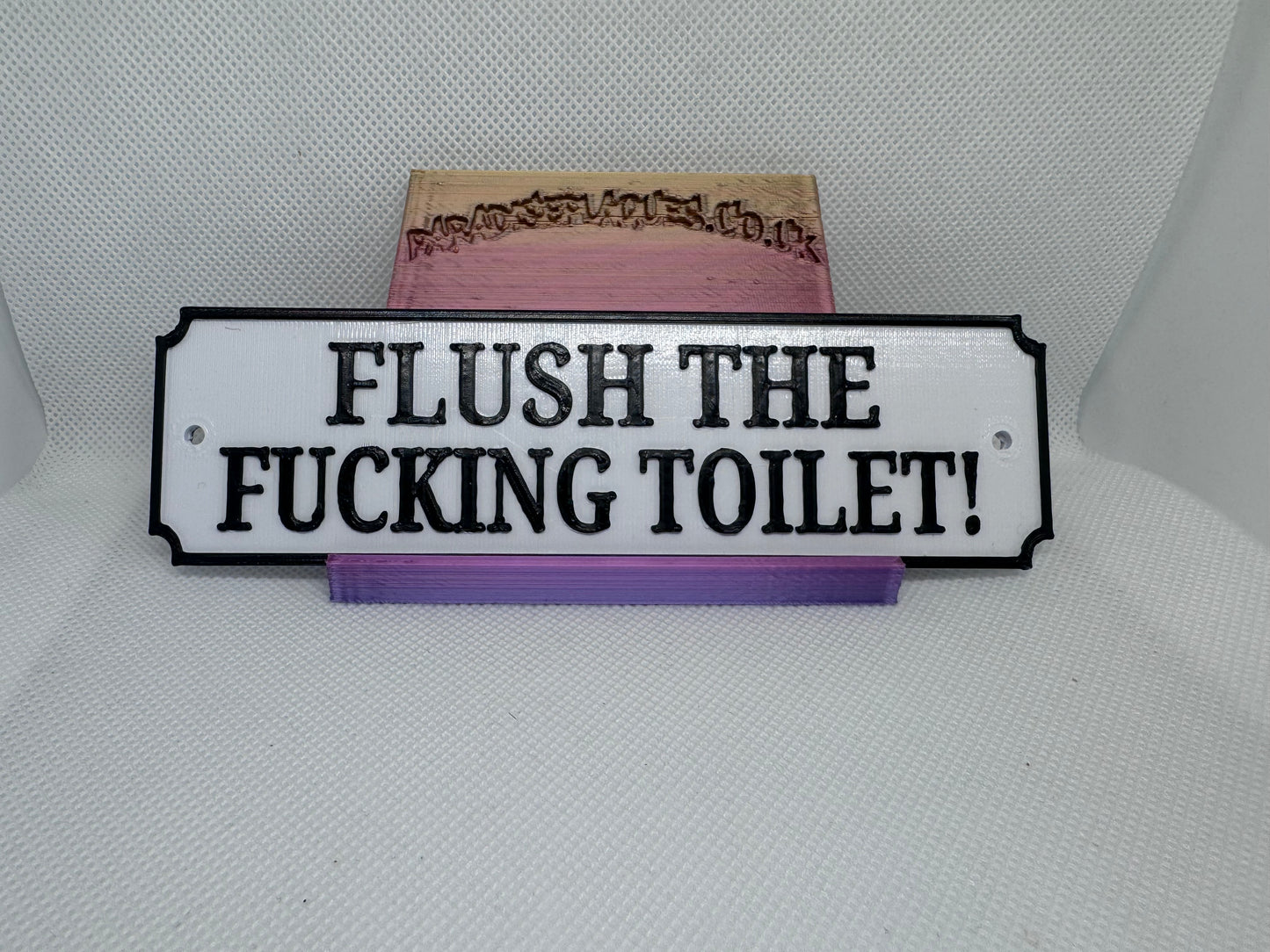 Flush the fucking toilet plaque